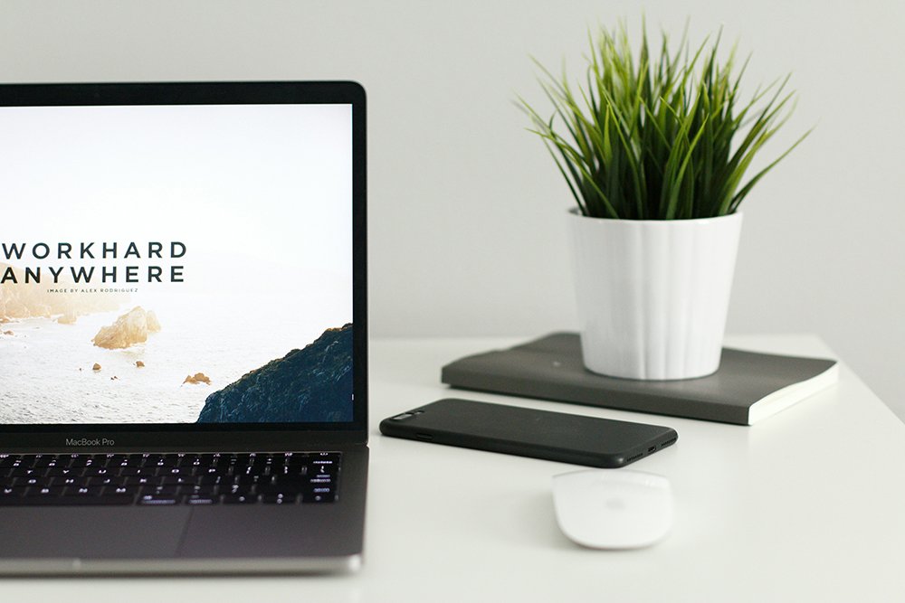 laptop with the phrase "Work hard anywhere" on the screen